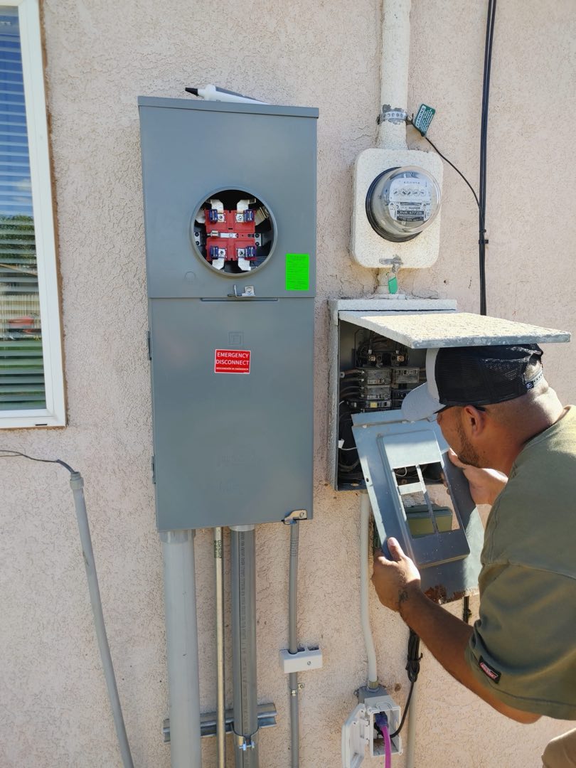 Felipe of Quality Electric working on an electrical meter and panel