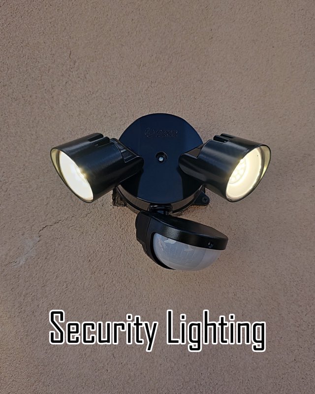 Twin-head motion security light mounted on a stucco wall